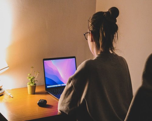 person working on a laptop at home in Italy